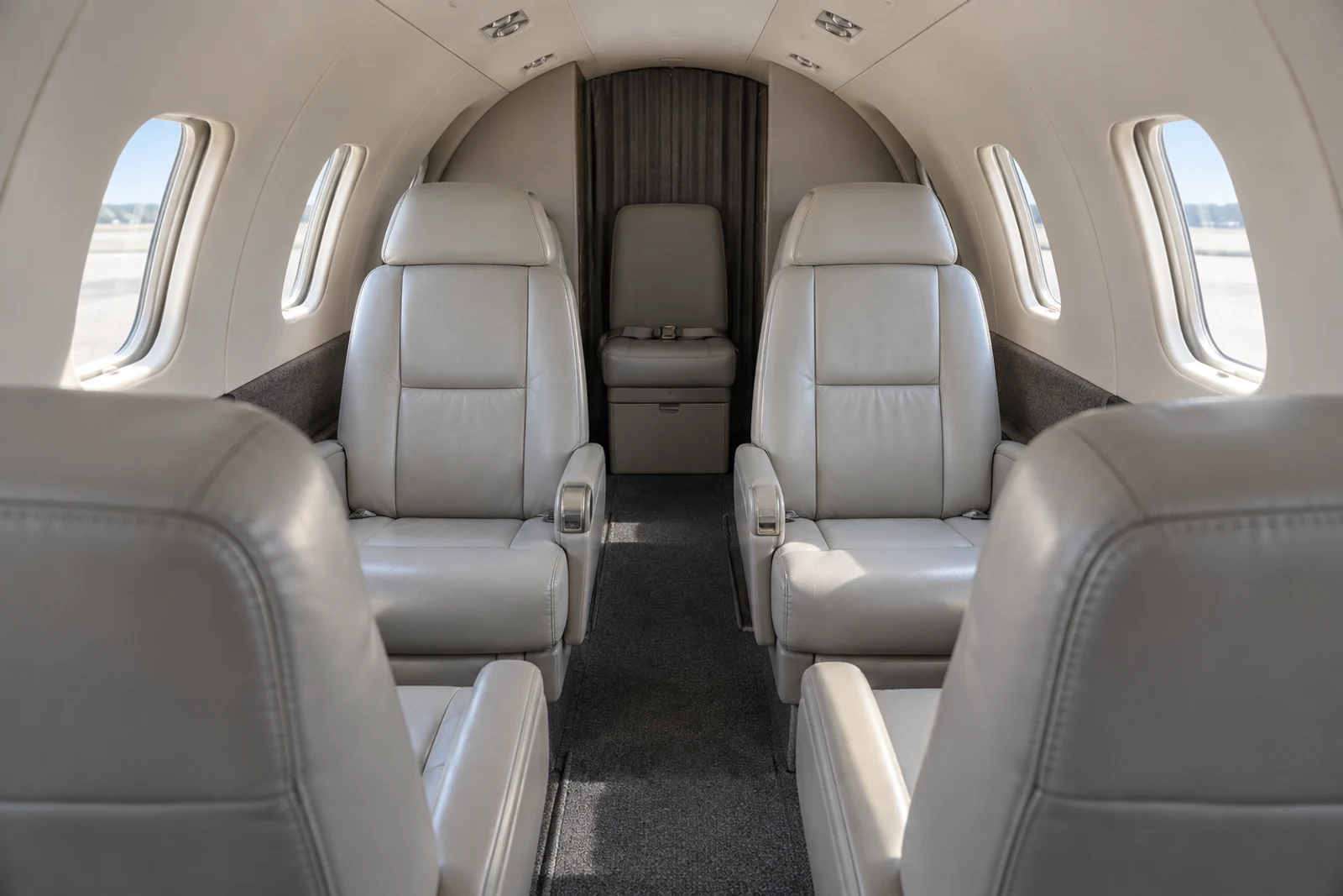 Citation 501 six-position passenger example cabin illustration. Actual layout and equipment vary; not a photograph of this aircraft.