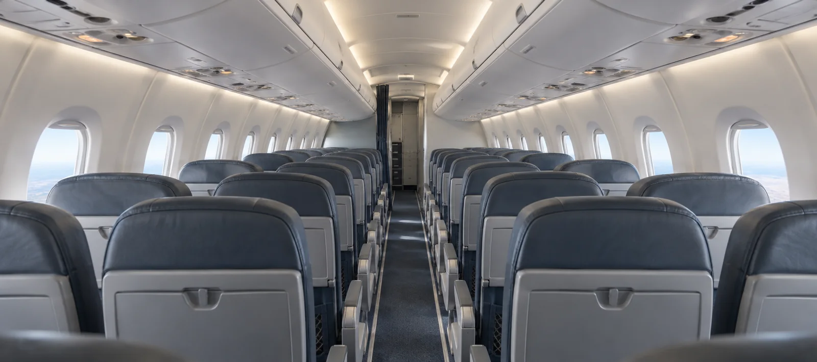 Bombardier CRJ1000 cabin interior illustration: aI-generated illustration of a representative Bombardier CRJ1000 cabin, looking forward through the 2+2 passenger seating.