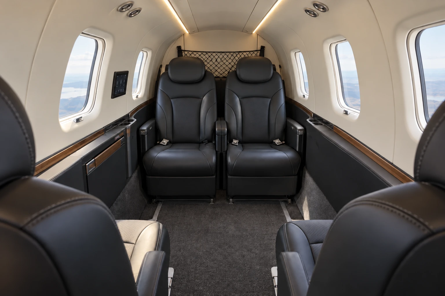 Daher TBM 960 cabin interior illustration: representative TBM 960 Prestige club cabin looking aft, with four cabin seats in two opposed pairs.