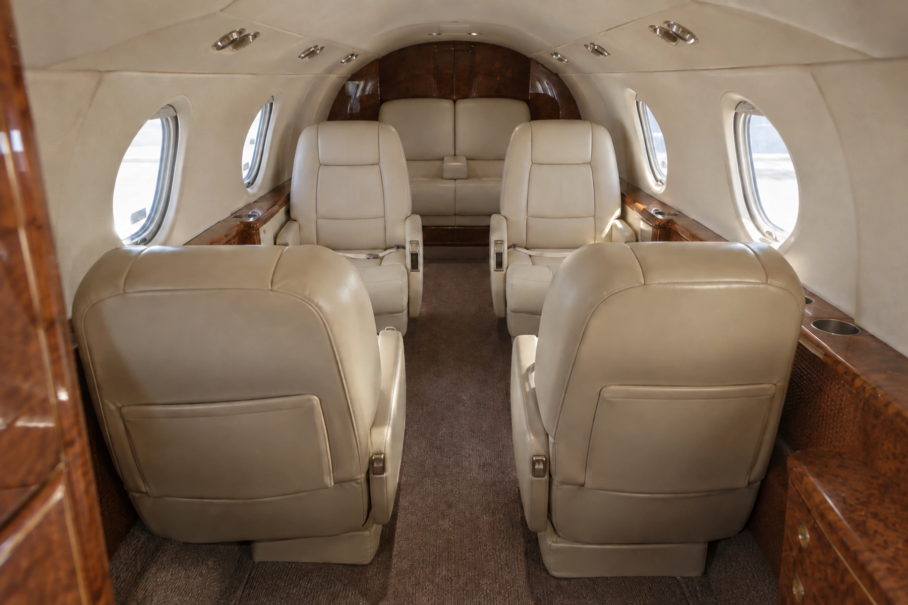 Dassault Falcon 10 (certified family) cabin interior illustration: falcon 10 seven-seat example. Illustrative interior, not a photograph of this aircraft.