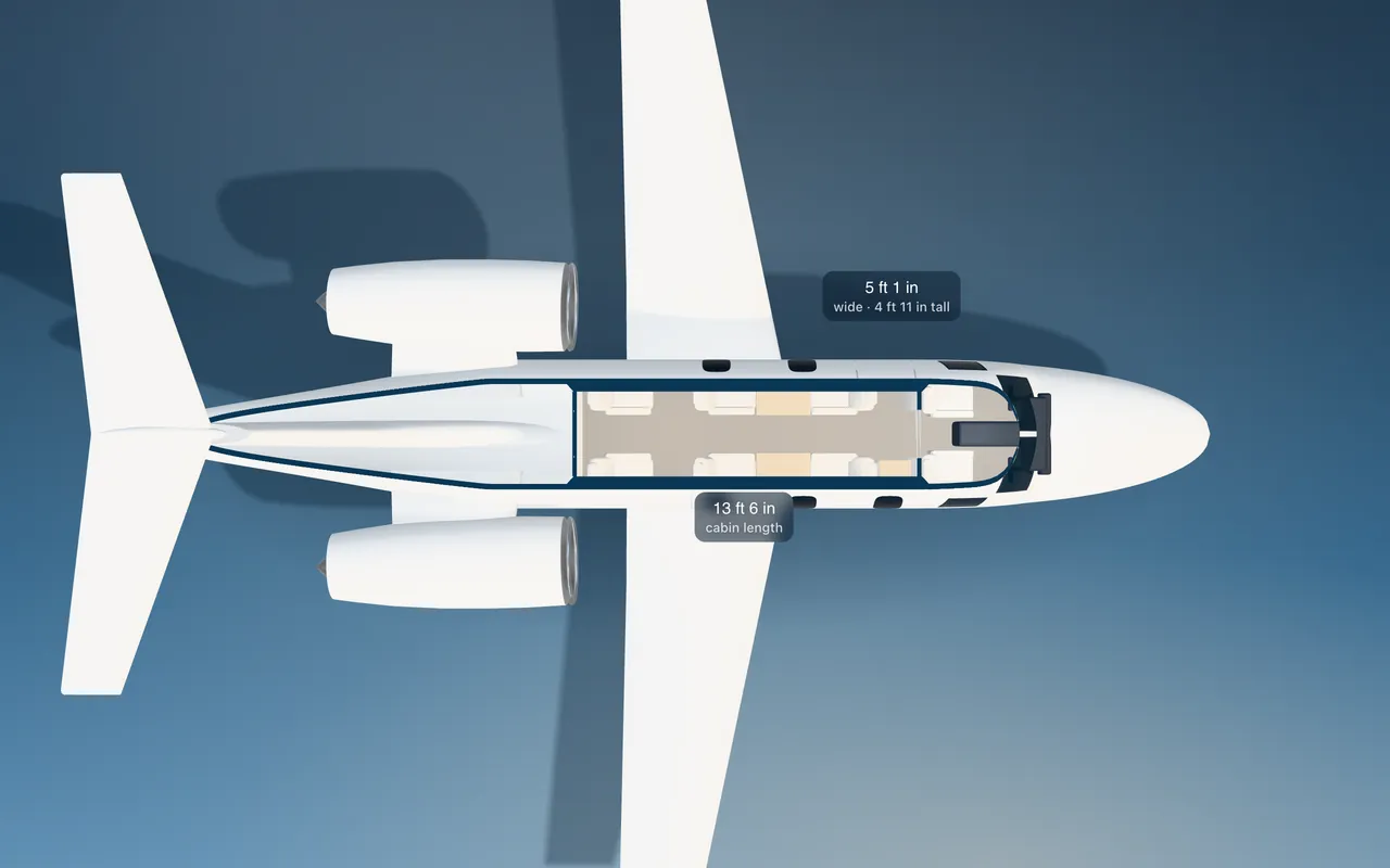 Embraer Phenom 100 3D seat map illustration: plan view cut through the 13 ft 6 in cabin, with a representative 6-seat layout.