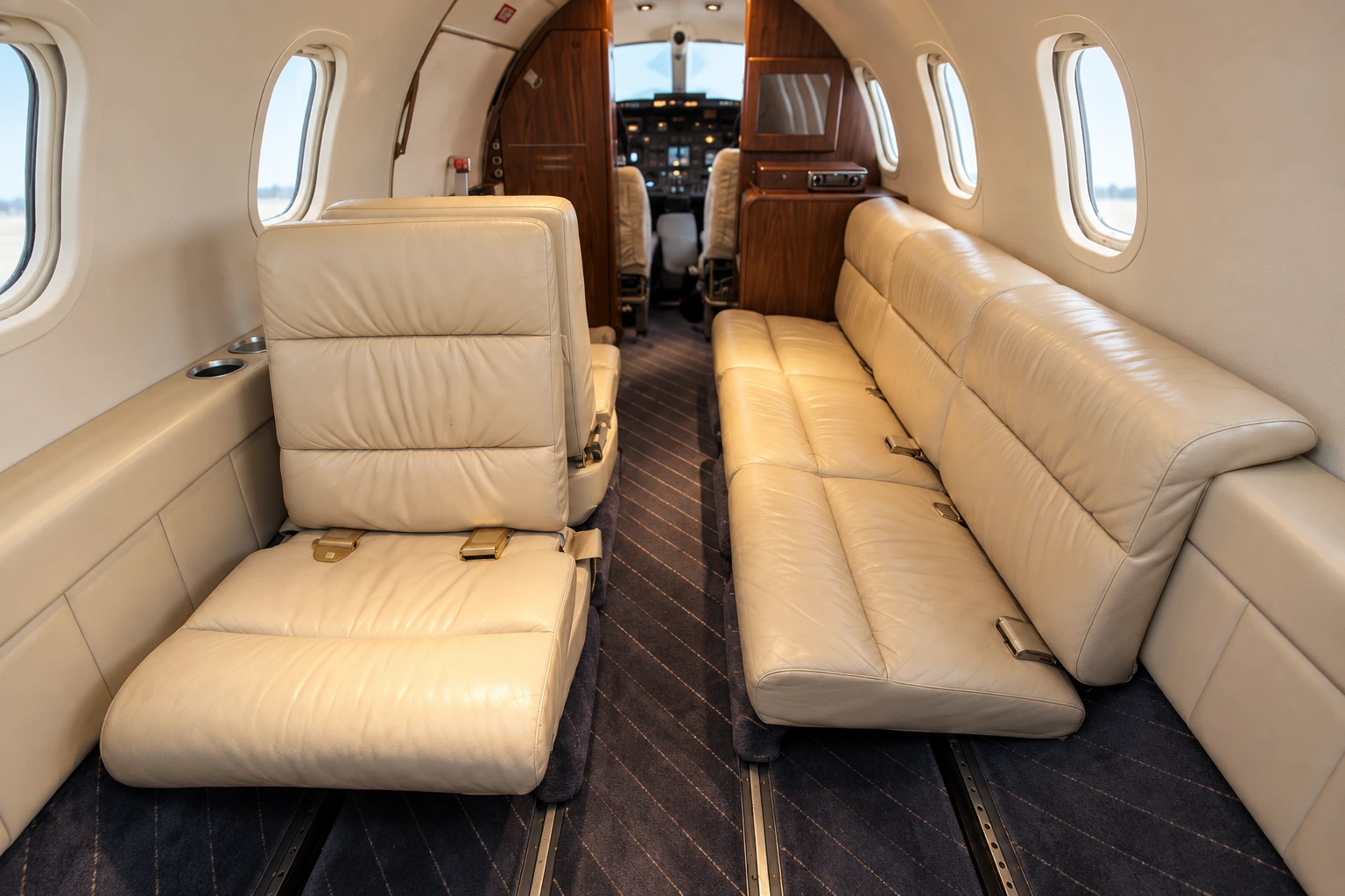 Learjet 25D (certified family) cabin interior illustration: representative Learjet 25D cabin view looking forward. Actual completions vary.