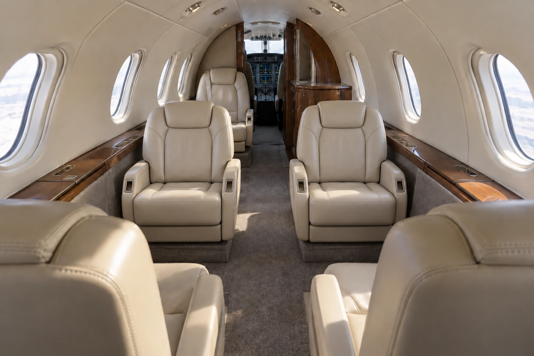 Representative Hawker 400XP cabin looking forward through a compact seven-seat completion; actual interiors vary.