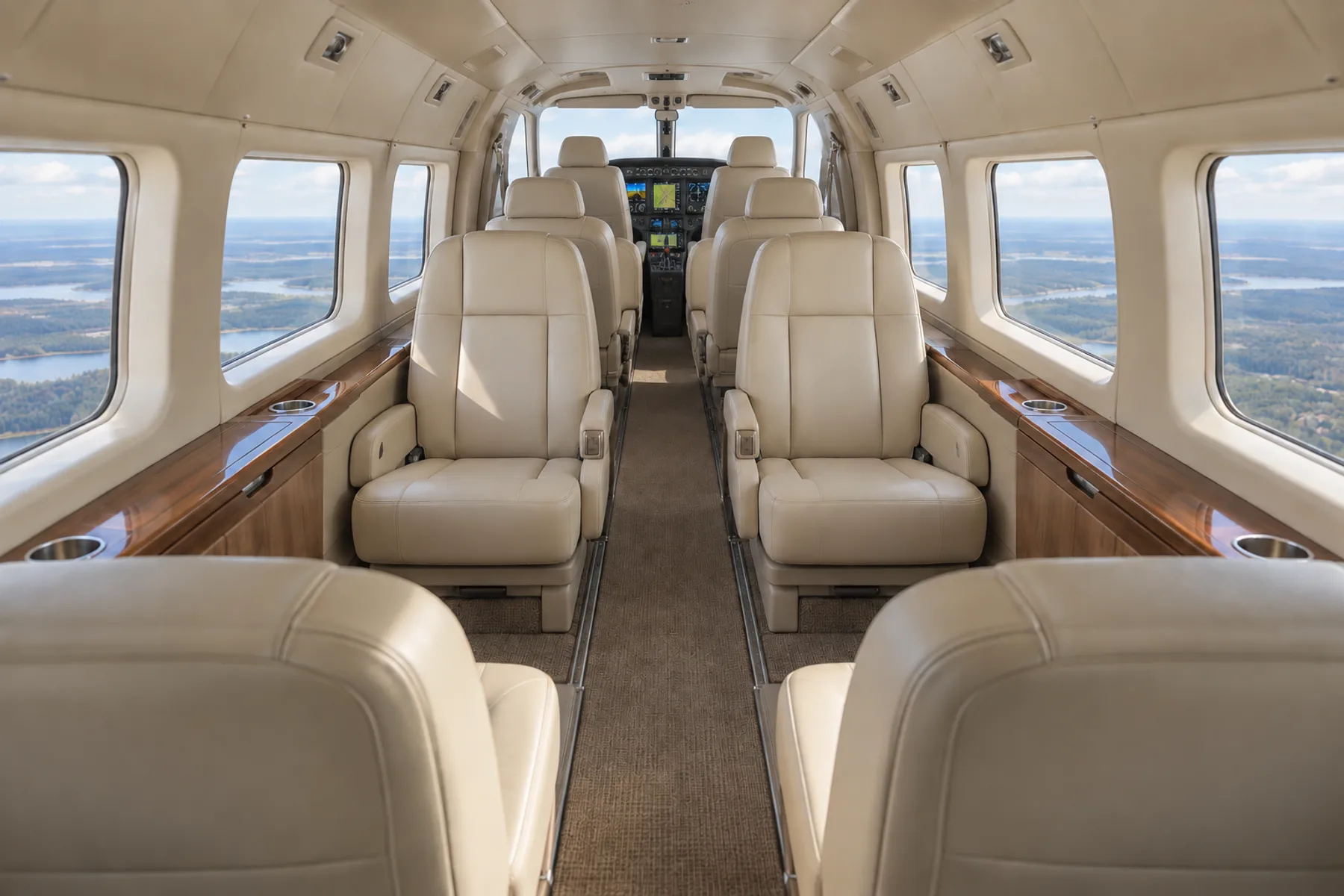 Representative Grand Caravan EX cabin looking forward through the opposed club toward two forward passenger chairs and the cockpit