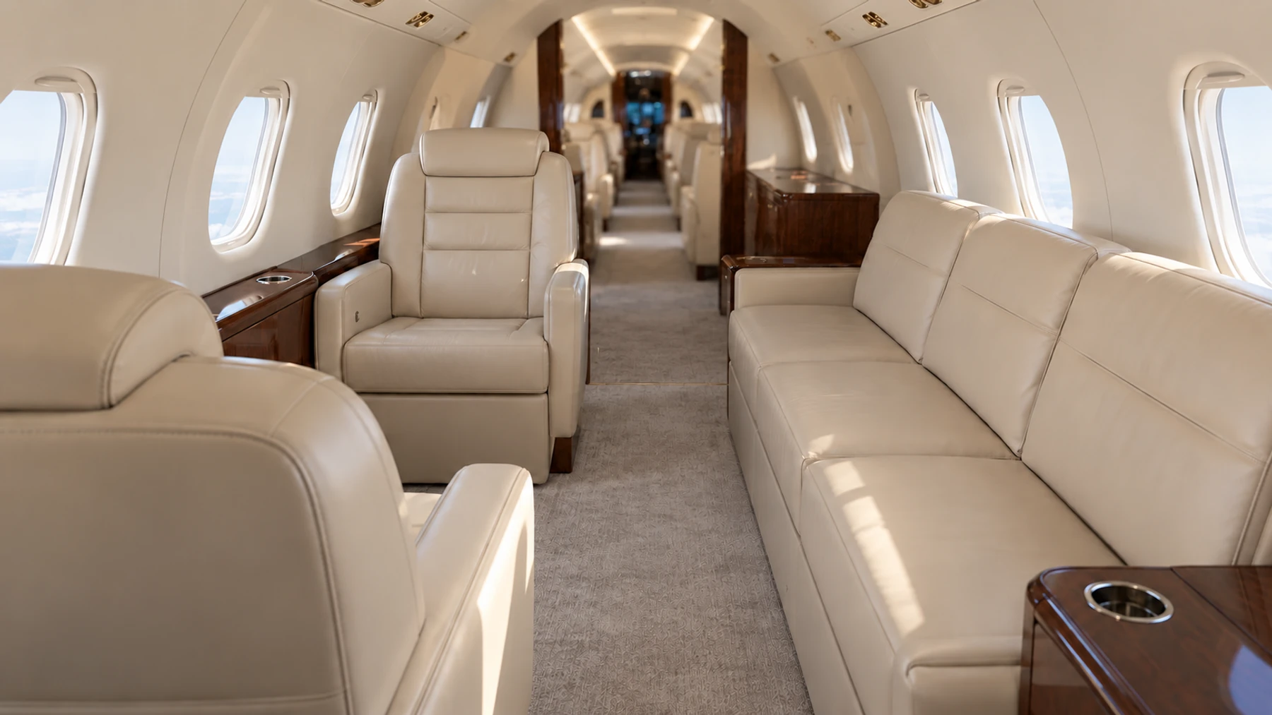 Falcon 20 nine-passenger example. Illustrative aft lounge detail, not a photograph of this aircraft. Four forward chairs are outside this view.